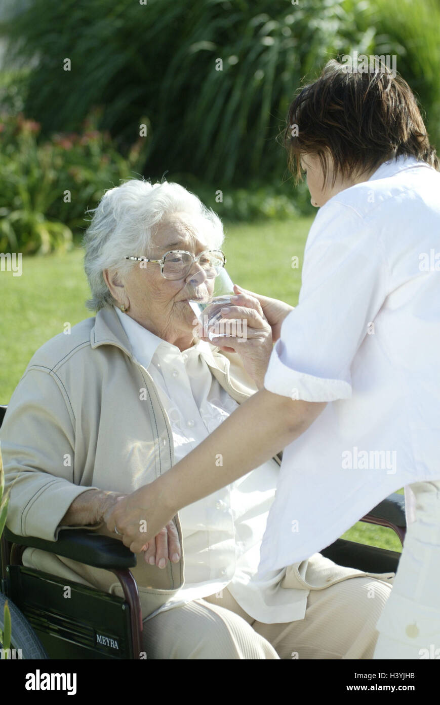 Senior, invalid, wheel chair, water glass, drink, old nurse, help old people's home, old people's home, senior citizen's home, garden, park, woman, old, old person, pensioner, pensioner, nurse, glass, water, drink, help, concern, allowance, support, care, Stock Photo