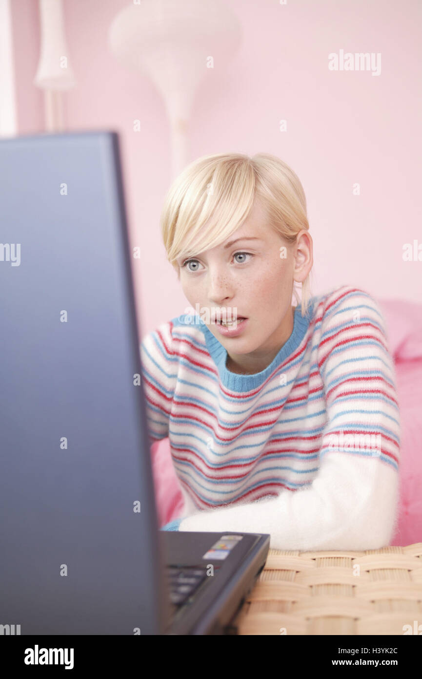 Young persons, blond, notebook computer, data processing, concentration, 16 - 20 years, woman, young, laptop, computer, data entry, chat, Internet surfing, interest, attention, information, is surprised, astonished, amazed, surprises, telecommunication, communication, leisure time, holidays, privately, at home, inside Stock Photo