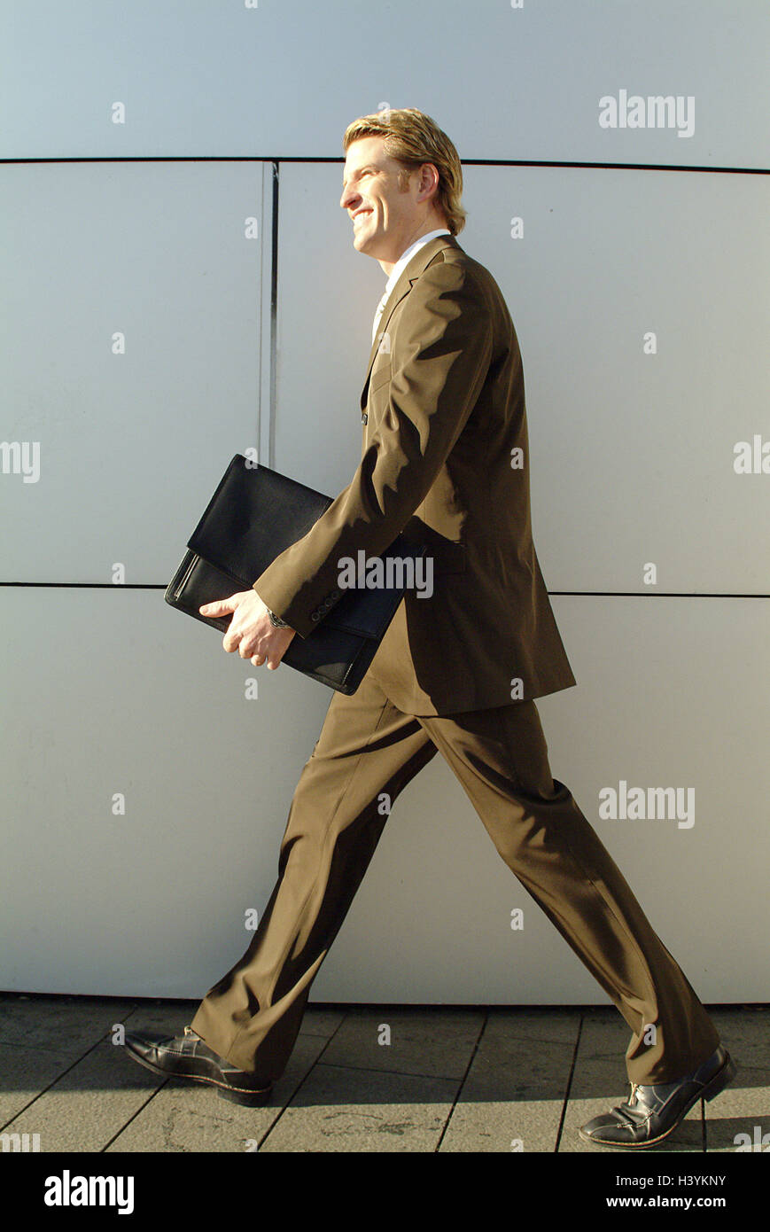 Buildings, man, young, smile, go briefcase, business, occupation, job, businessman, manager, banker, elegantly, confidently, resolutely, purposefully, ambitiously, successfully, certainly about victory, contently, proudly, ambition, success, working way, Stock Photo