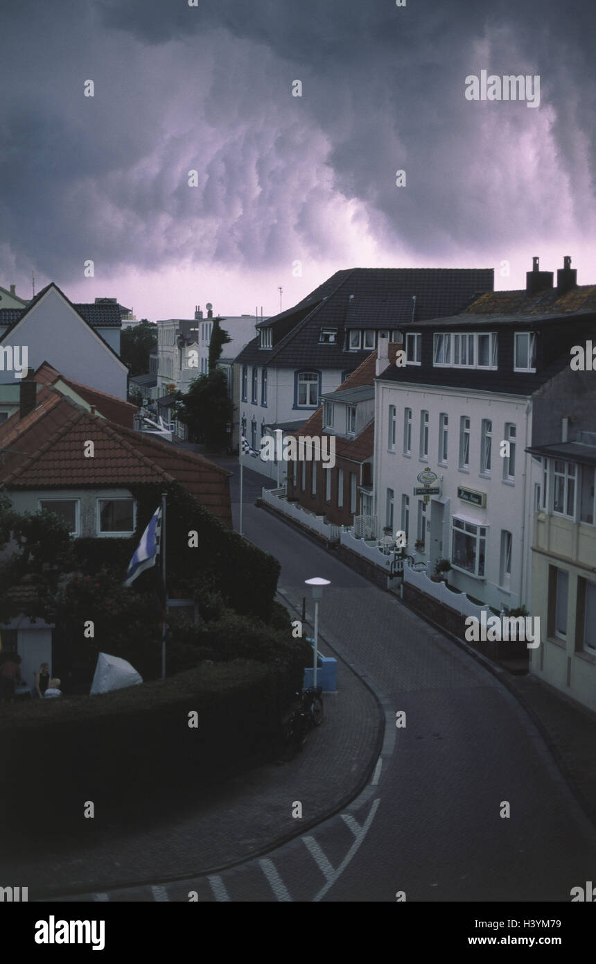 Germany, Lower Saxony, island Norderney, Norderney, city centre, residential houses, stormy atmosphere, Europe, North Germany, the North Sea, North Sea island, island, town, houses, road train, weather, beautyful clouds, cloudy sky, darkly, gloomily, mena Stock Photo