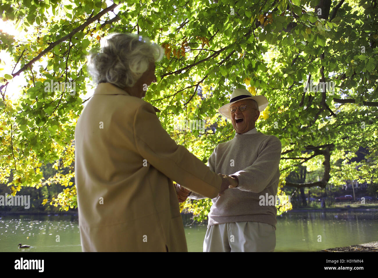 Park, Senior couple, happy, dance couple, senior citizens, partnership, friendship, Before, respect, happy, falls in love, love, affection, together, laugh, hold exuberance, cheerfulness, Ringlet-purely, eye contact, hands, dance, fun, joy, joy life, enterprising, park, river, riverside, care, headgear, glasses, wearers glasses, late summers, tenderness dance couple, Stock Photo