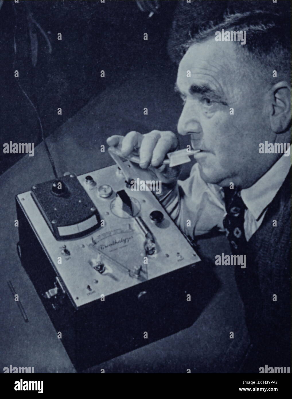 Photograph of an early breathalyser being demonstrated in London. The