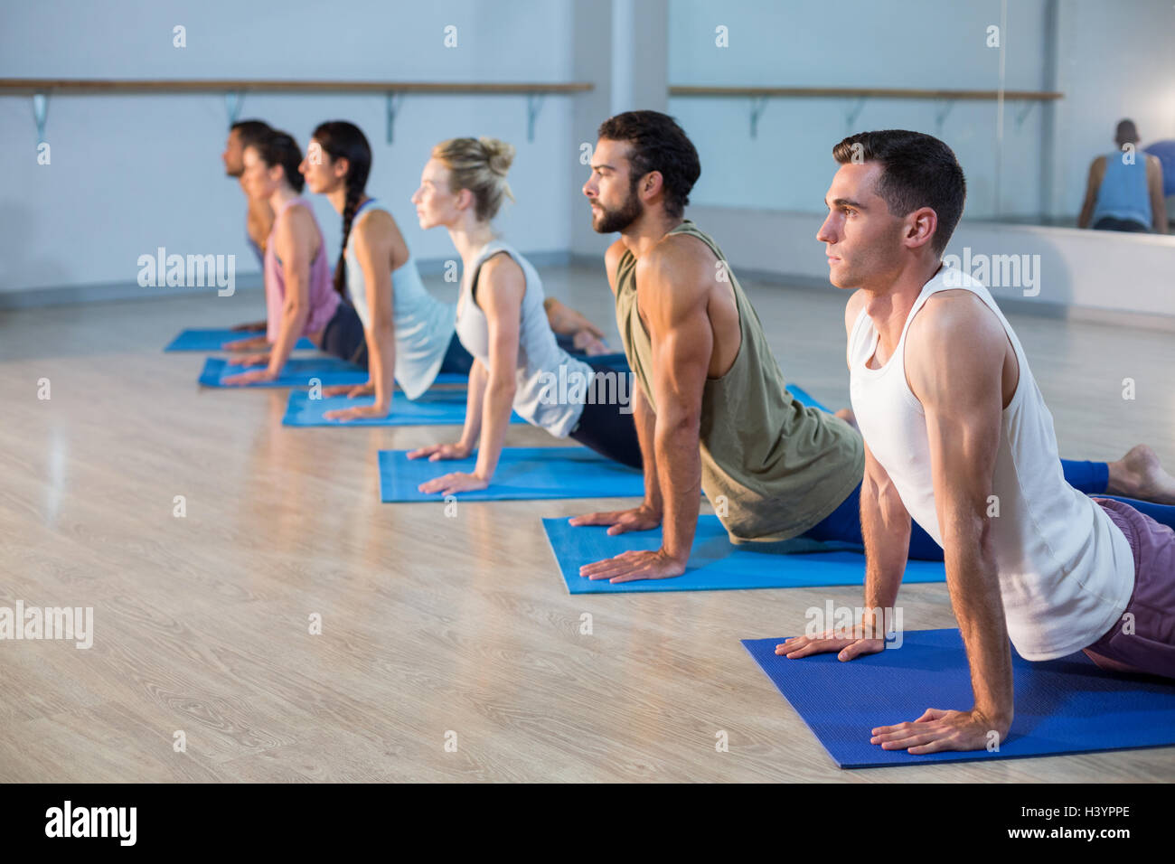 Group of people performing yoga Stock Photo - Alamy