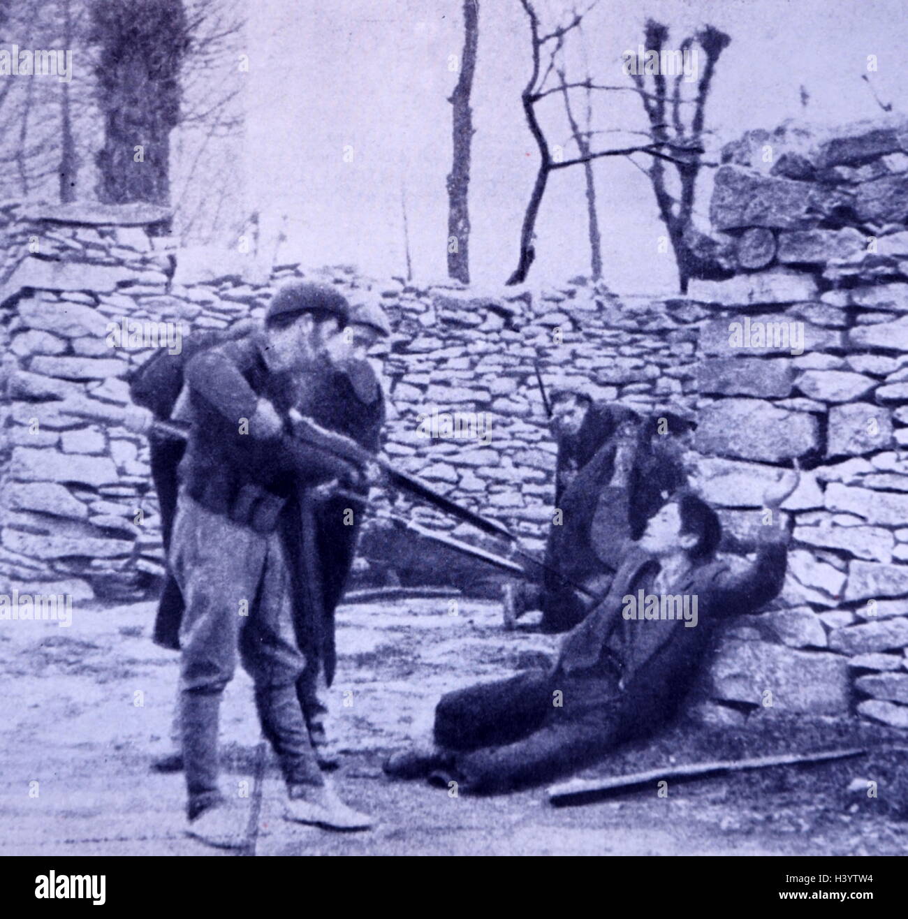 Photograph of Francoist Spanish legionnaires with a captive. Dated 20th Century Stock Photo