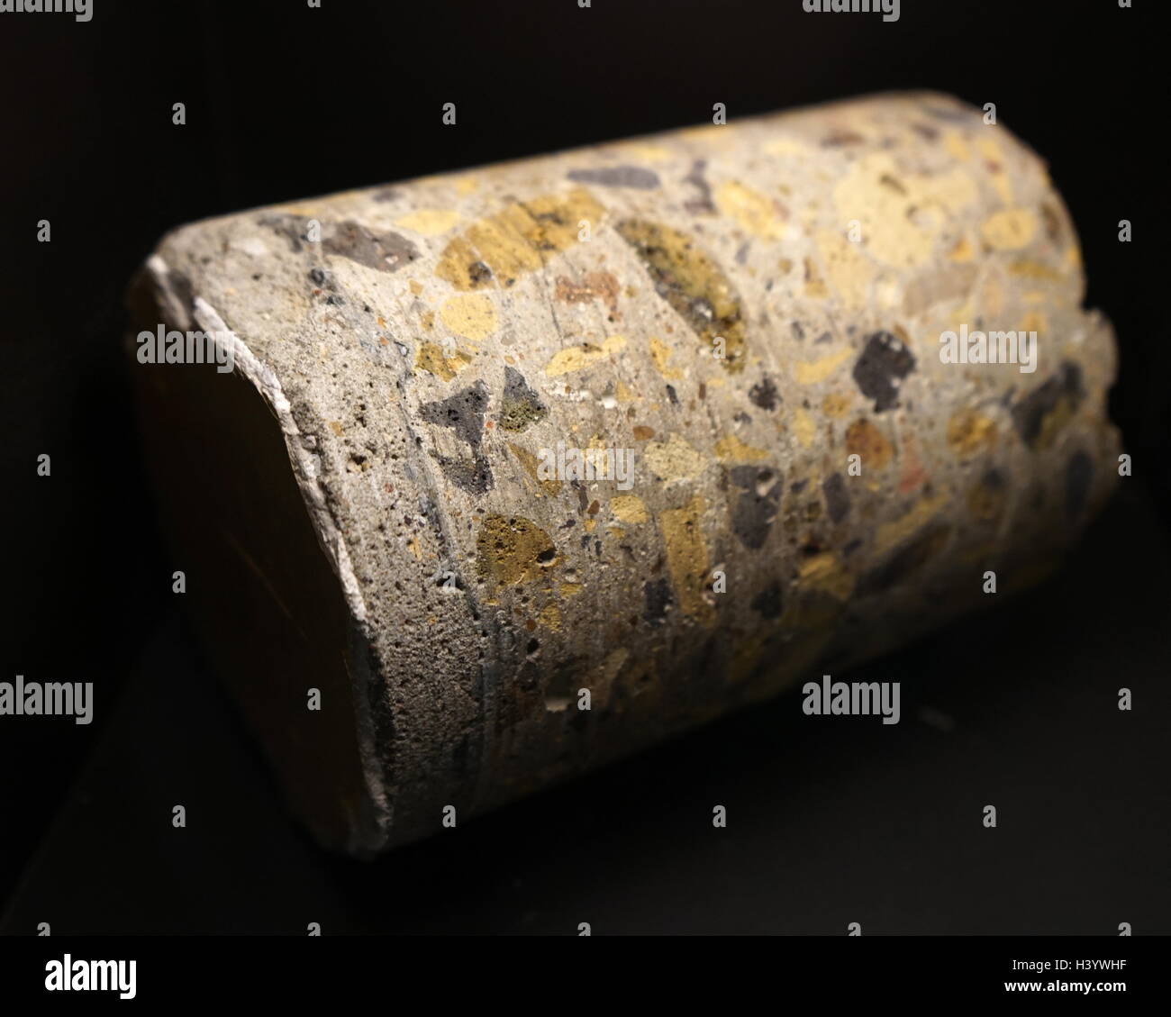 Sample of natural concrete, made from fragmented rock with deposited