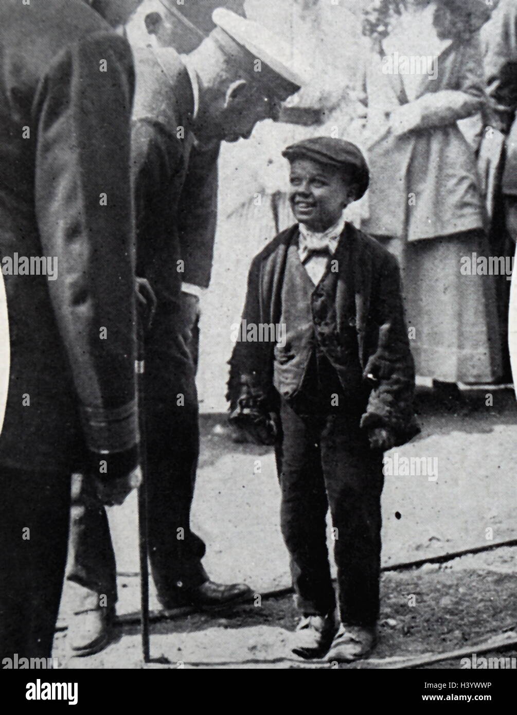 Photograph of King George V (1865-1936) meeting a young child worker during the First World War; Stock Photo