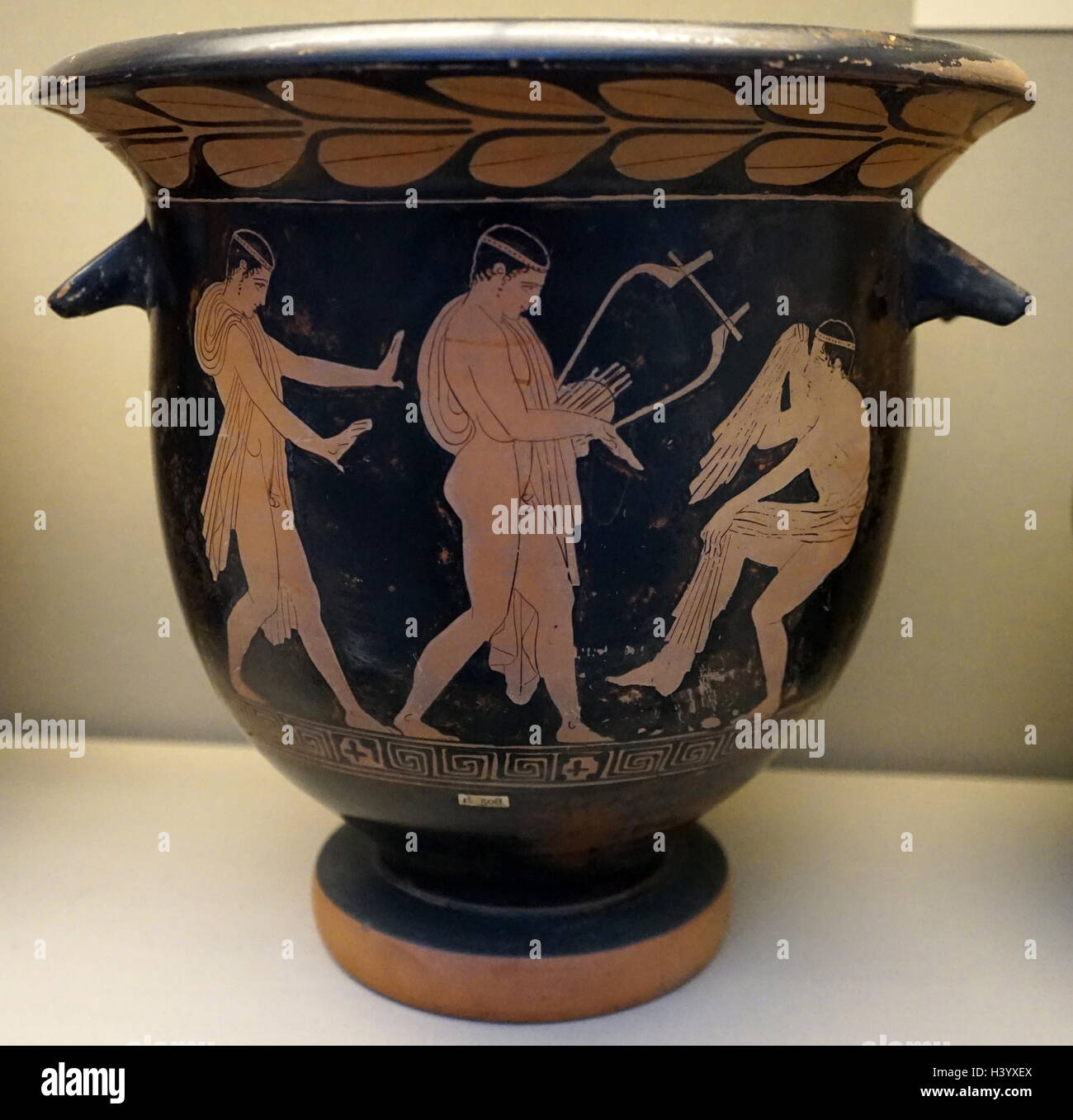 Red-figured bell-krater depicting three revellers from ancient Greece. Dated 5th Century BC Stock Photo