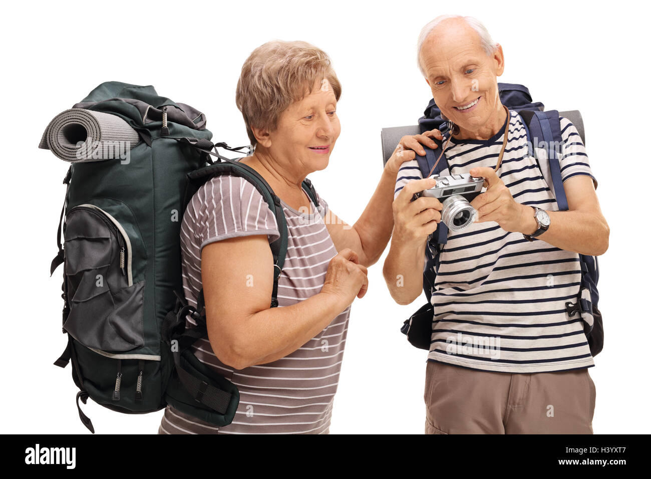 Senior hikers looking at a photograph on a camera isolated on white background Stock Photo
