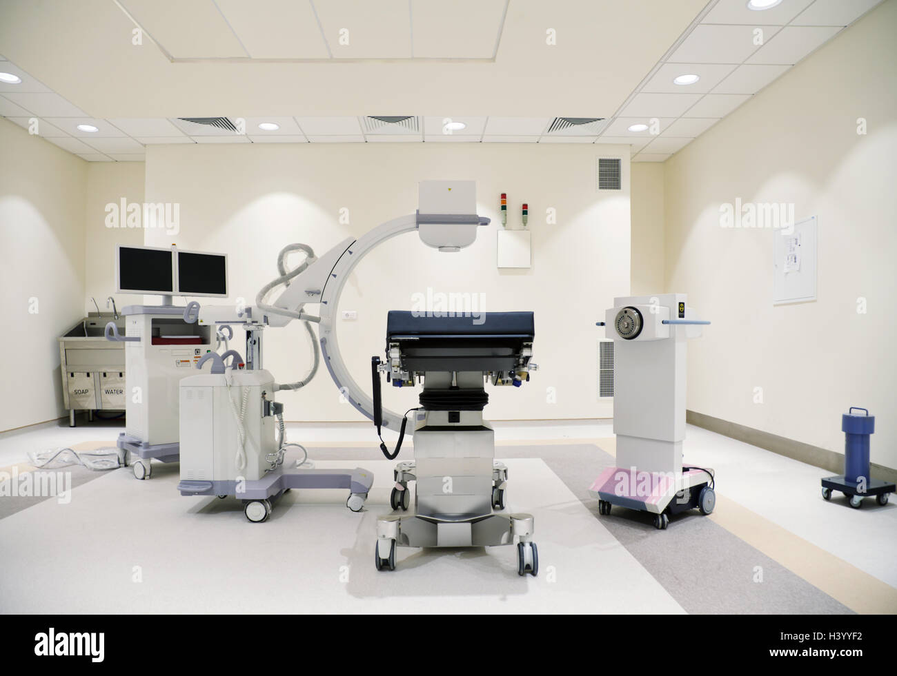 Modern hospital diagnostic center with C-arm probe and equipment, nobody. Stock Photo