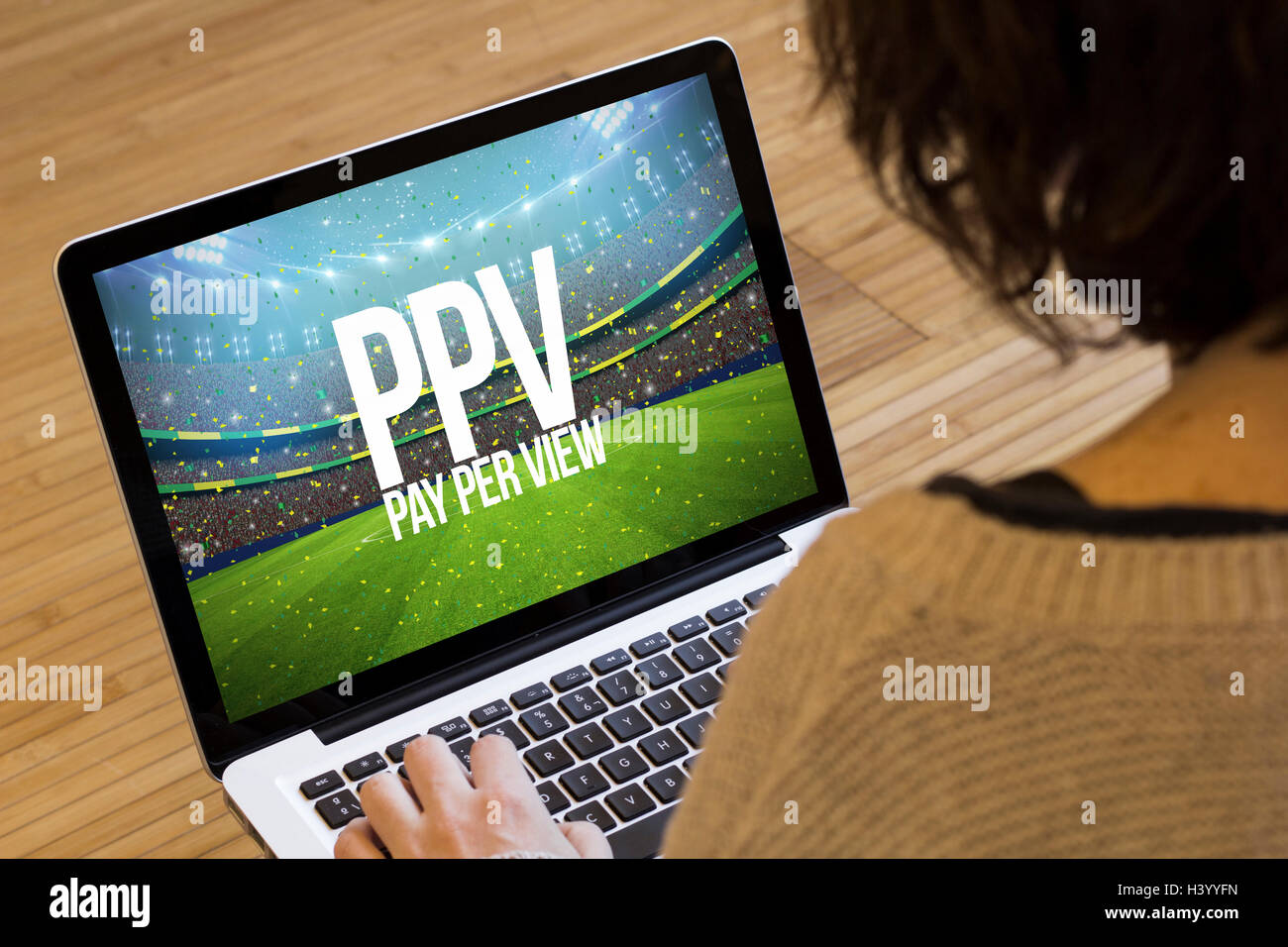 pay per view concept: ppv text on a stadium on a laptop screen. Screen graphics are made up. Stock Photo