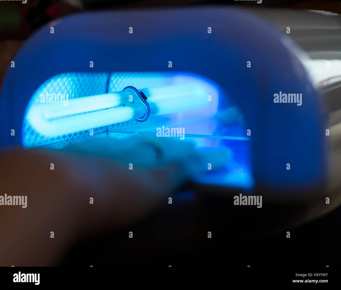 Drying in Nail enamel drying device, close up on bulb Stock Photo Alamy