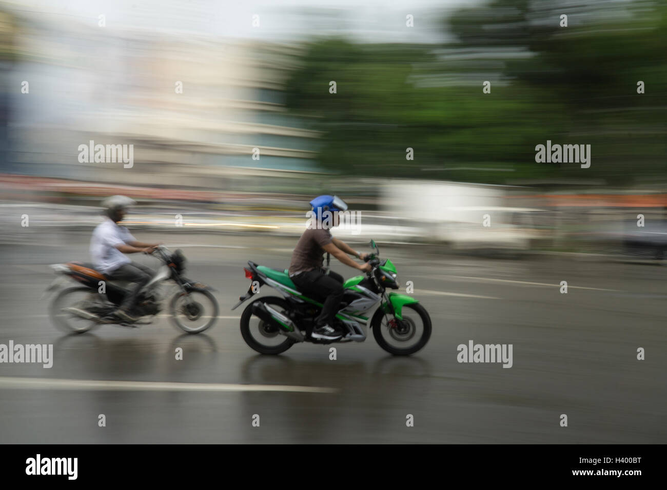 Slow camera shutter speed exaggerating movement of motorcycle riders in ...