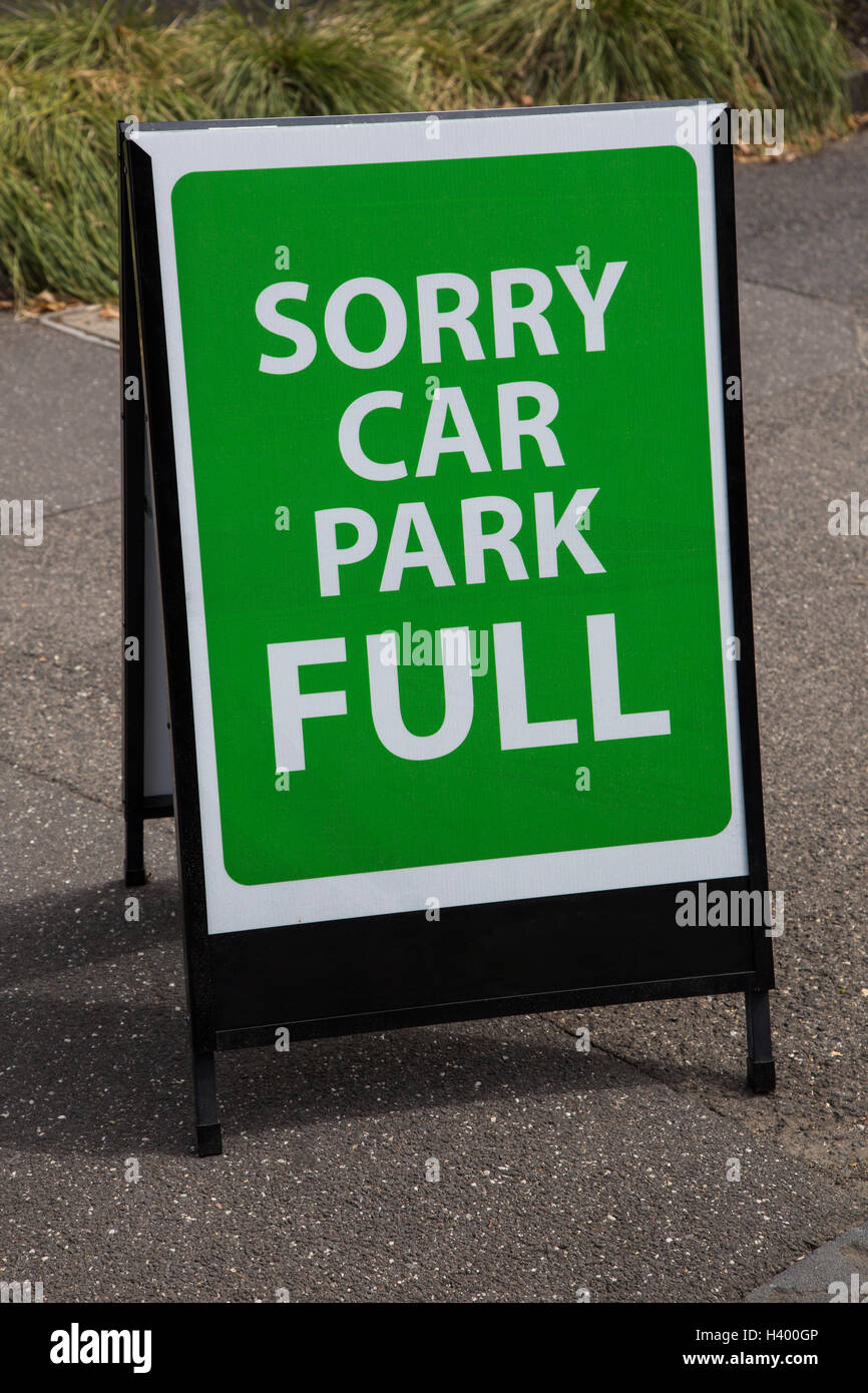 Green signboard on road at parking lot Stock Photo