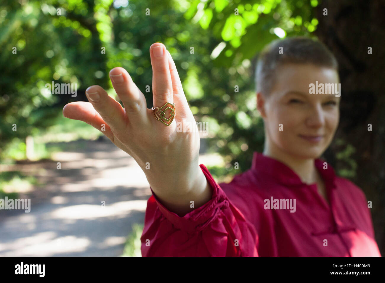 Woman wearing ring gesturing while practicing Tai Chi at park Stock Photo