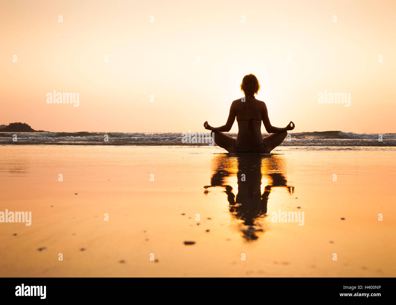 Woman practicing yoga on the beach, lotus position at Koh Chang, Thailand Stock Photo