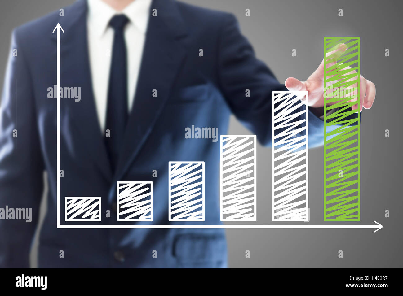 Businessman presenting a successful sustainable development on a bar chart Stock Photo