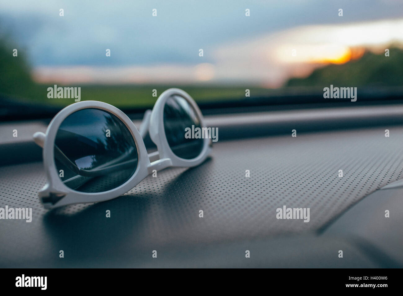 Closeup of sunglasses on car dashboard against windshield Stock Photo Alamy