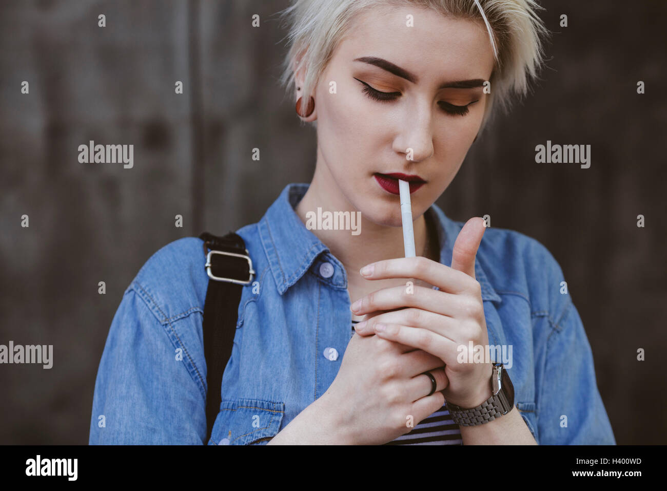 Woman lighting cigarette hi-res stock photography and images - Alamy