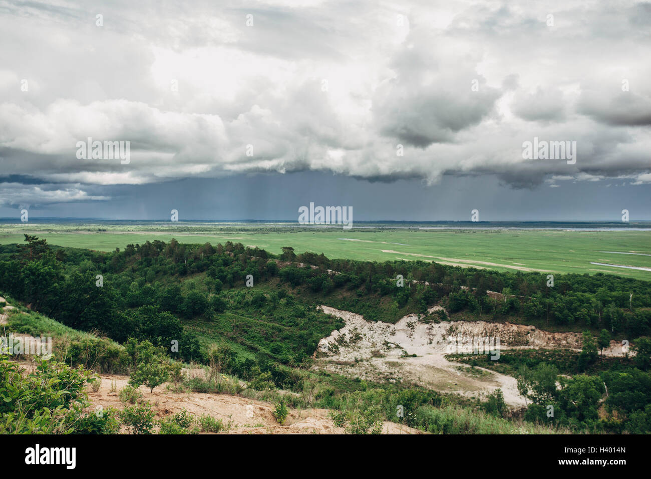 Scenic view of rural landscape against cloudy sky Stock Photo