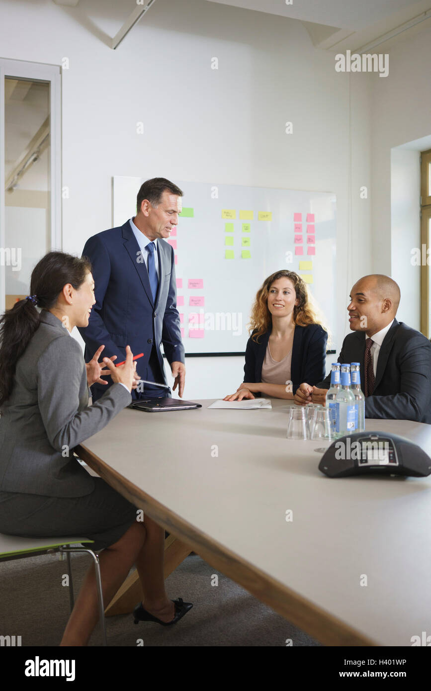 Happy business people discussing in meeting at conference table Stock ...