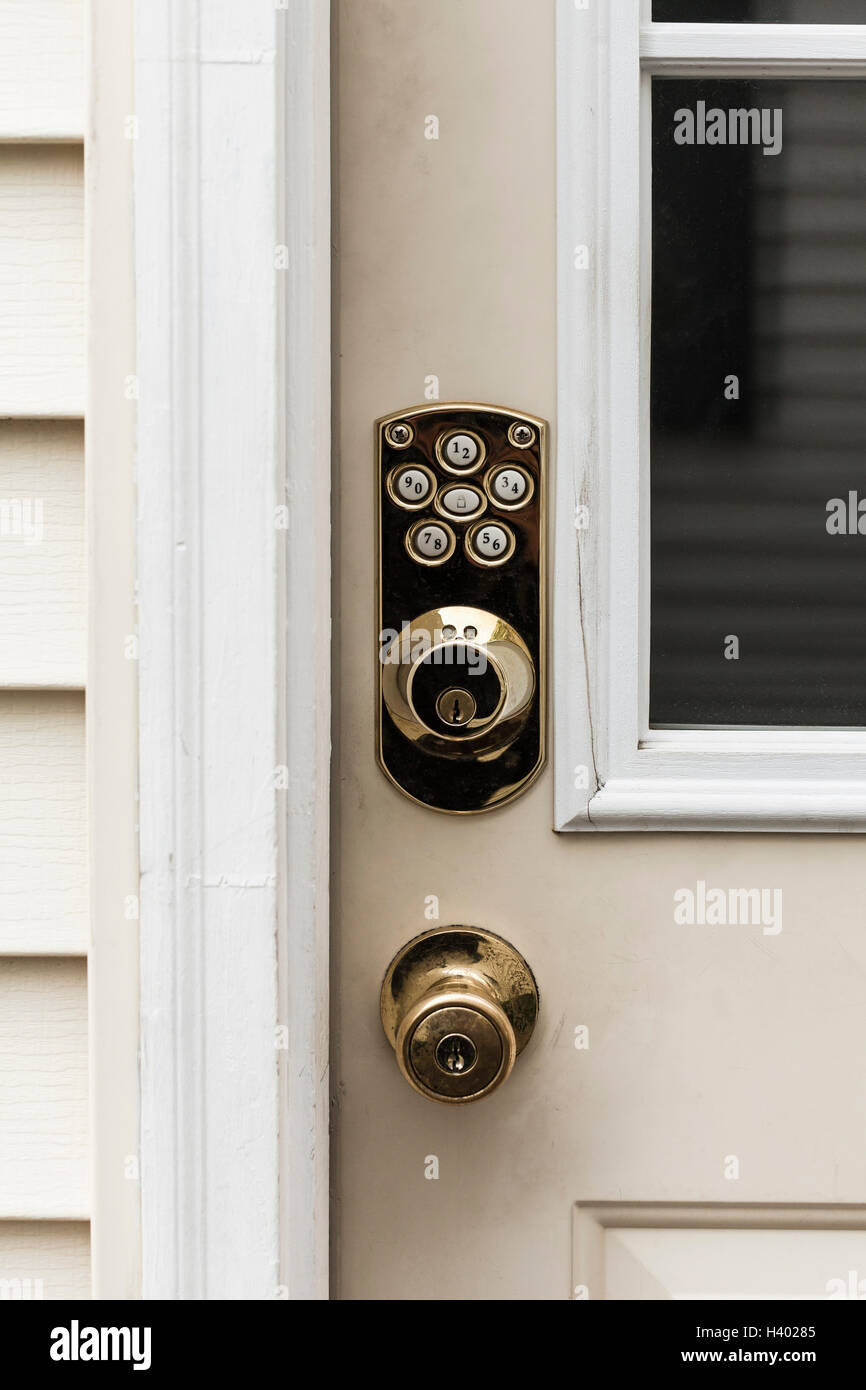 Close-up of shiny knob and locks on closed door Stock Photo