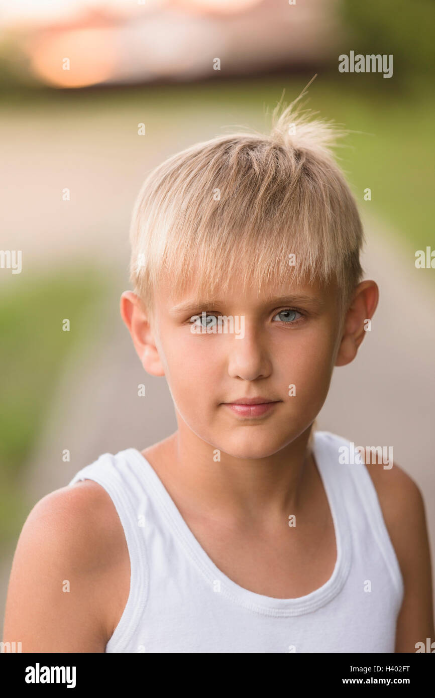 Portrait of confident boy with gray eyes standing at park Stock Photo