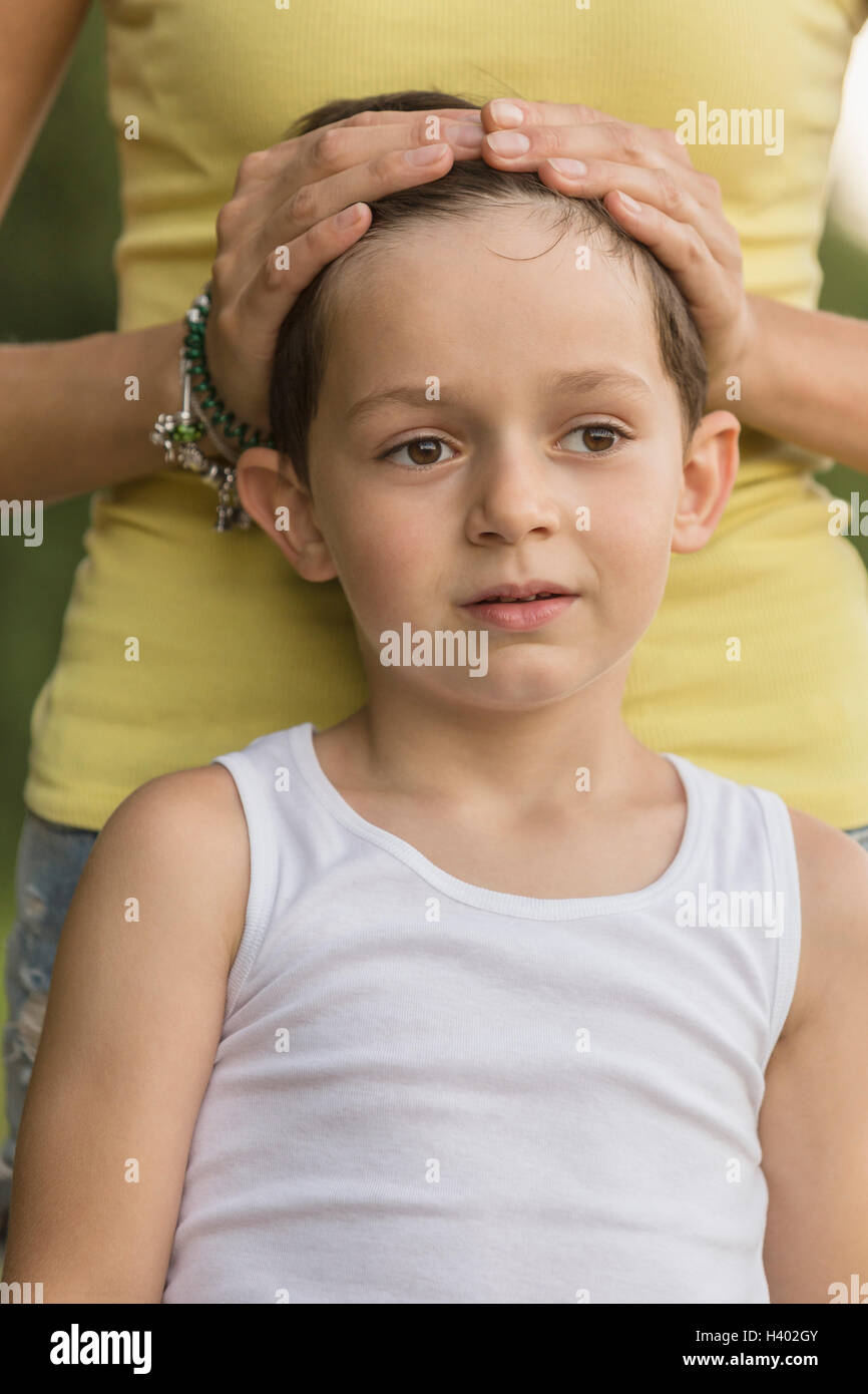 Midsection of woman standing with boy Stock Photo