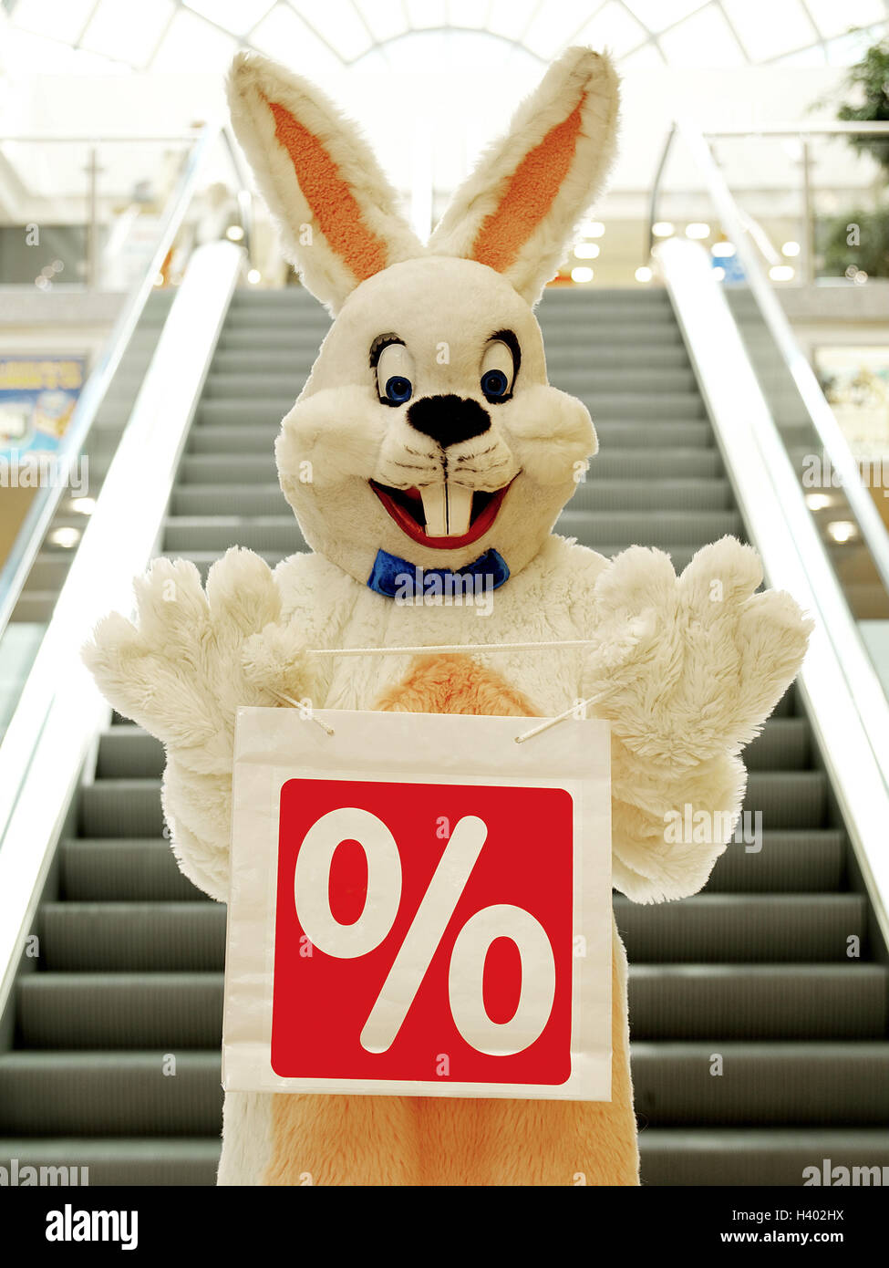 Department store, stairs, Easter bunny, carrier bag, label, percent sign Easter, Easter feast, child's faith, lining, panels, costume, hare's costume, hare, humor, fun, funnily, friendly, happy, joy, inside, purchasing, Easter purchasing, bargain purchase Stock Photo
