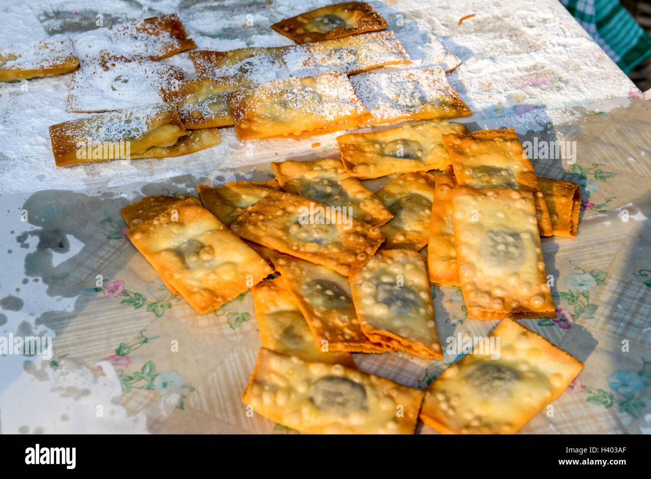 Street vendor while he is cooking the tasty pancakes Stock Photo