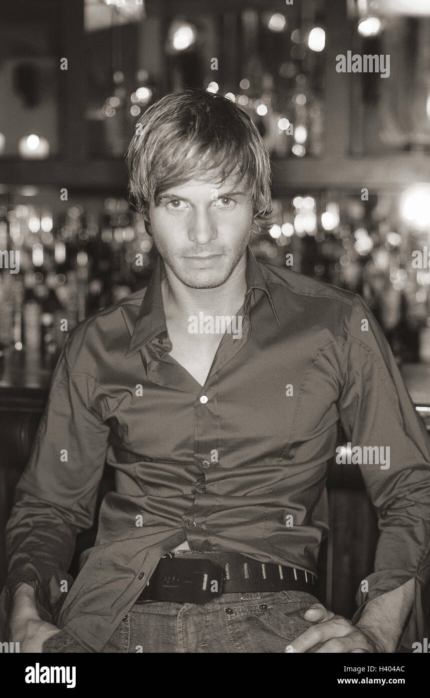Young man sitting on bar hi-res stock photography and images - Alamy