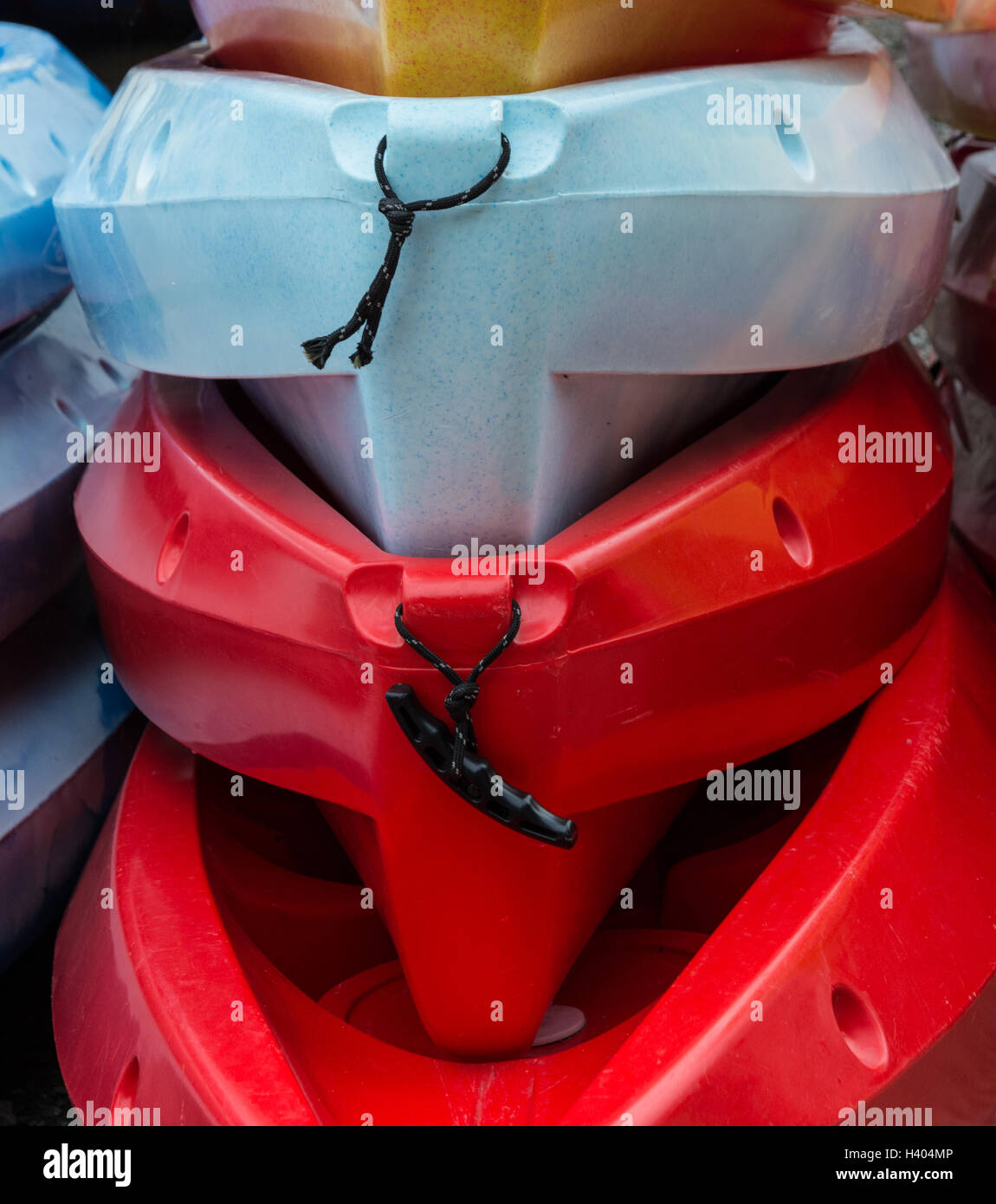 Vivid colours of plastic canoes stacked for storage Stock Photo - Alamy