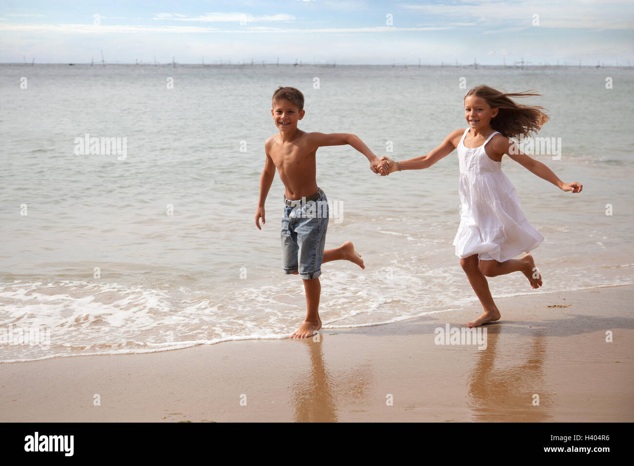 Boy And Girl Running Along Beach Holding Hands Stock Photo Alamy Boy And Girl Running Along Beach Holding Hands Stock Photo Alamy