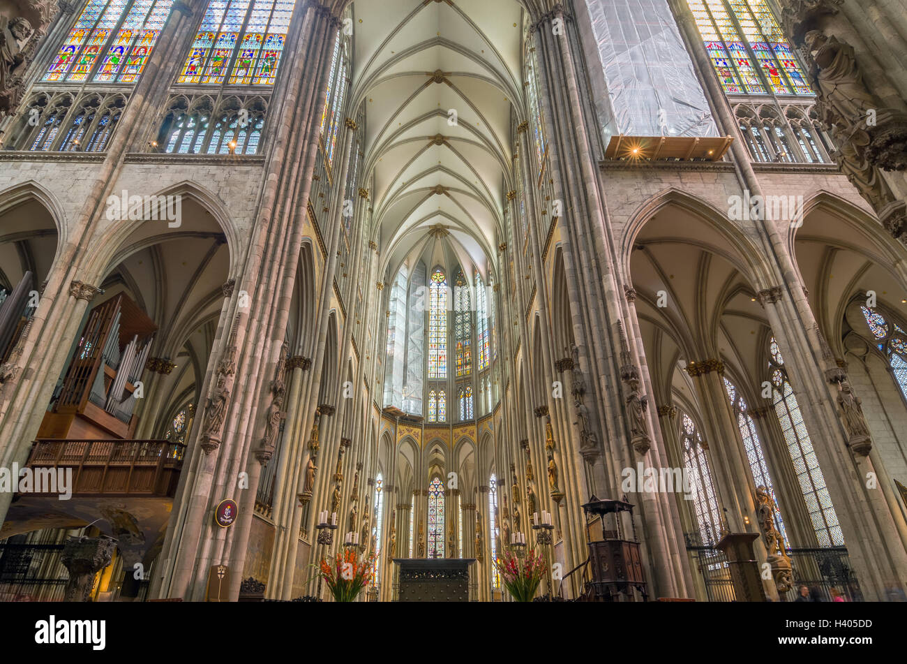 Interior of the Cologne Cathedral. Roman Catholic cathedral in gothic style. Nave, ceiling, organ, columns and stained glass. Stock Photo