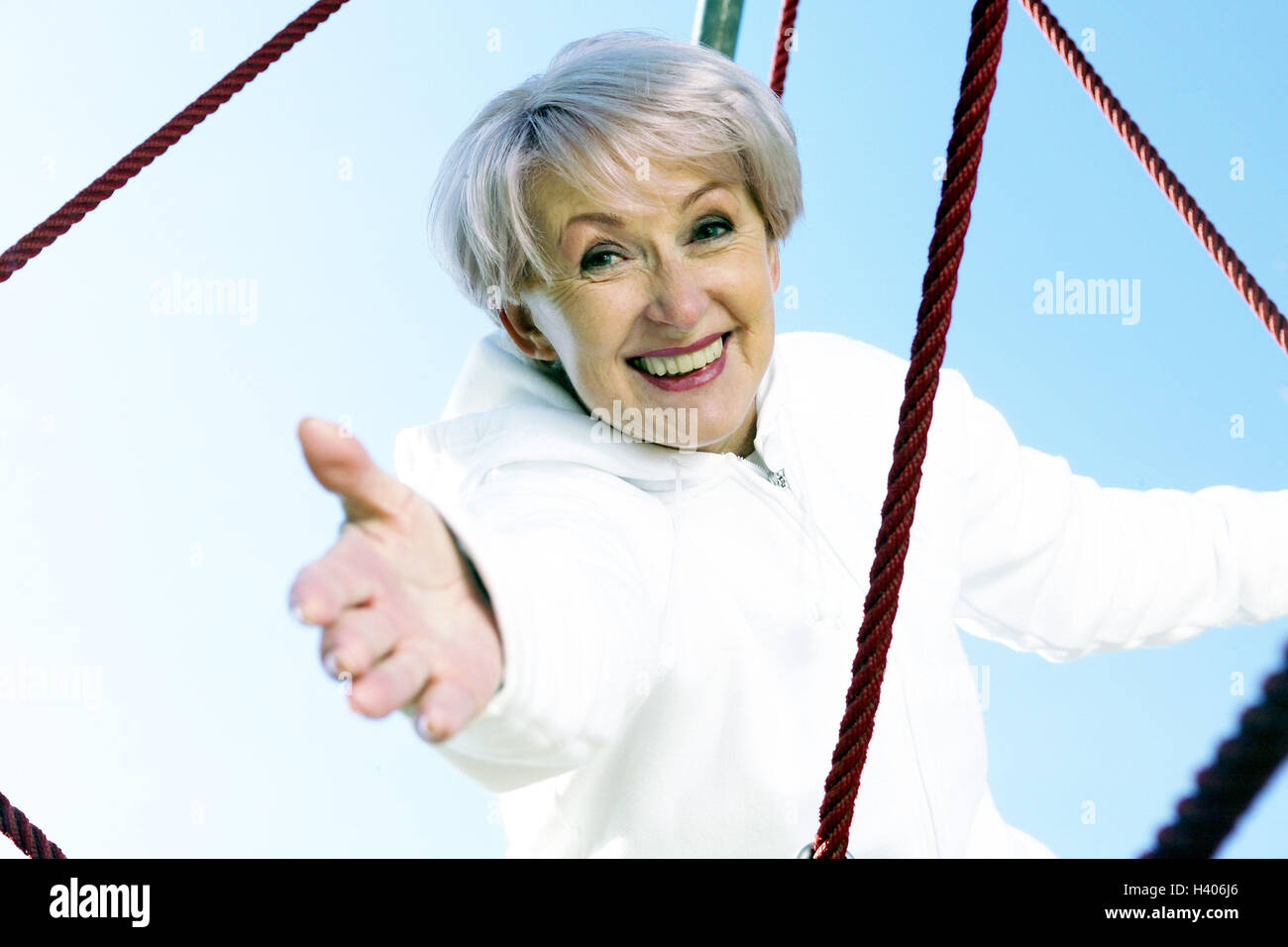 senior, casual wear, junglegym, laughing, putting forth one's hand, happy, help,portrait Stock Photo