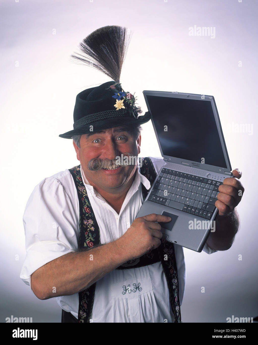 Man, leather ball trousers, notebook computer, facial play, enthusiasm inside, clothes, in Bavarian, Bavarian, cable beard, schnauzer, computer, portable, present, happy, joy, enthusiastically, open-mindedness, senior, studio, cut out, view camera, near Stock Photo