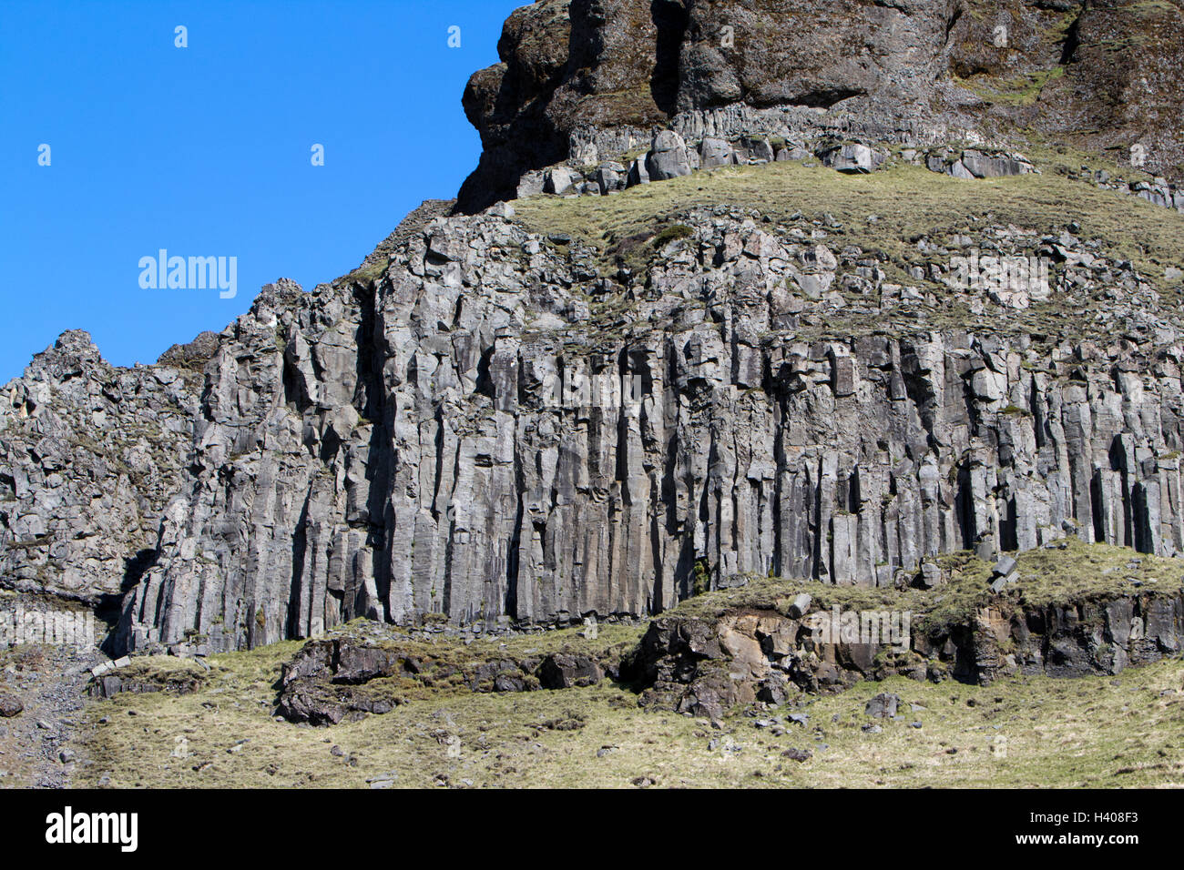 basalt columns volcanic rock formations in cliffs near the sea Iceland Stock Photo