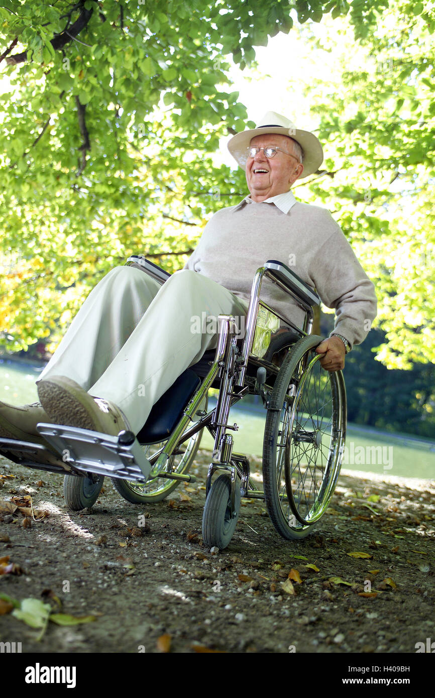 Park, boss, cheerfulness, invalid's wheel chair, sit, enjoy man, pensioner, invalid's wheel chair driver, glasses, wearers of glasses, care, headgear, fun, happily, joy of life, nature, riverside, way, obstacle, difficulty, handicap, ease, easily Stock Photo