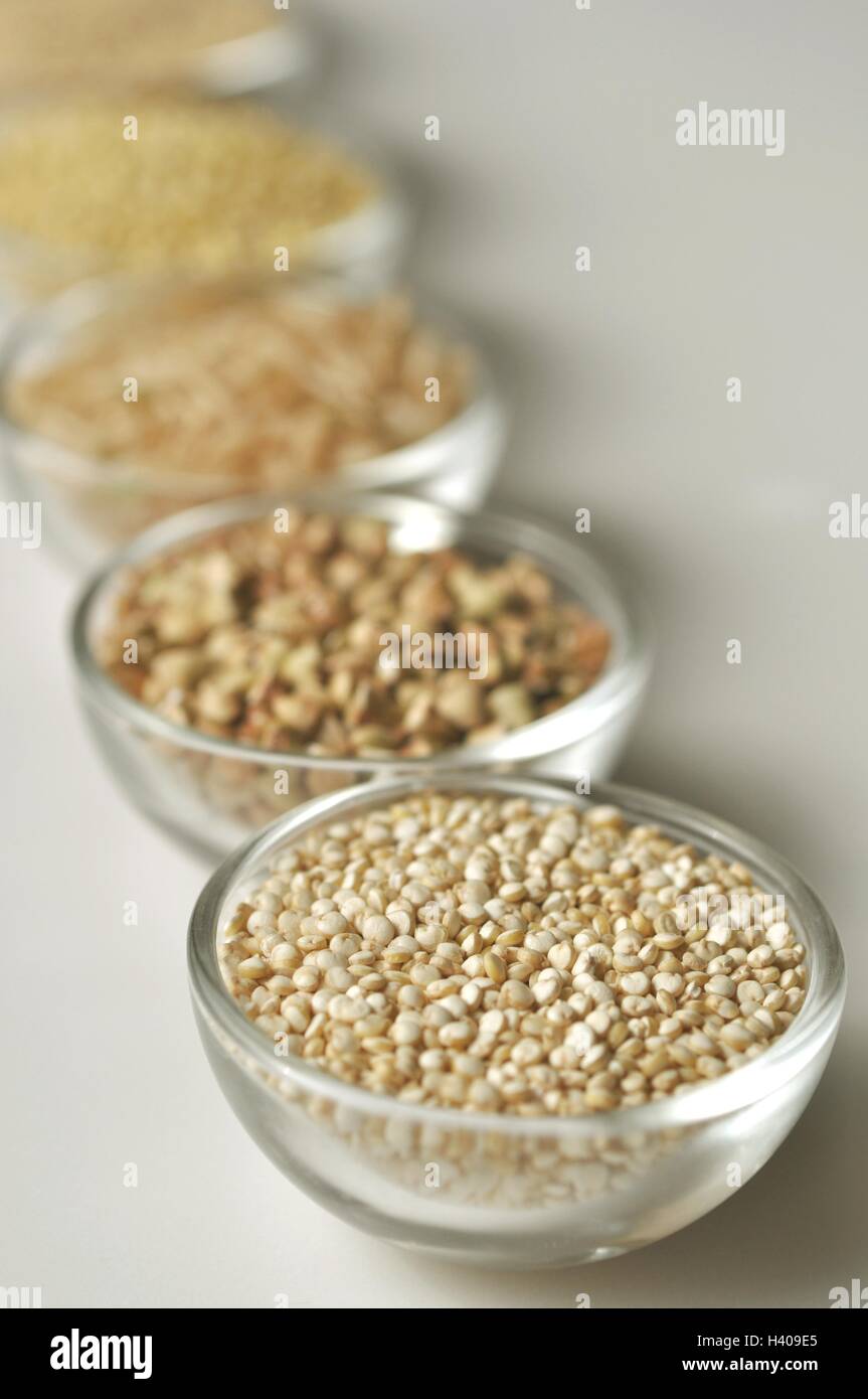 Quinoa and other glutenfree cereal grains in glass bowls, vertical