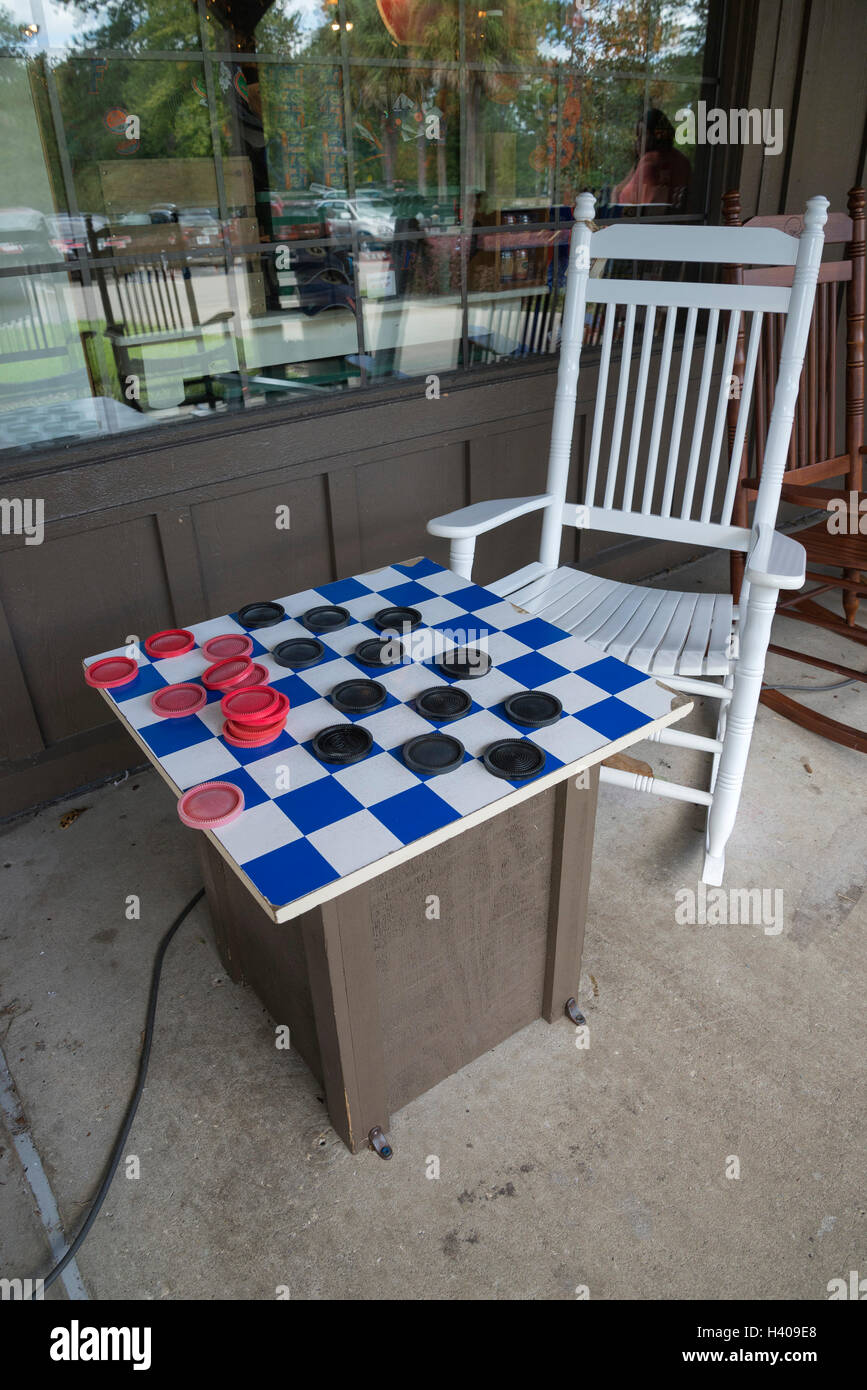 Giant checker set with rocking chairs in front of a Cracker Barrel restaurant. Stock Photo