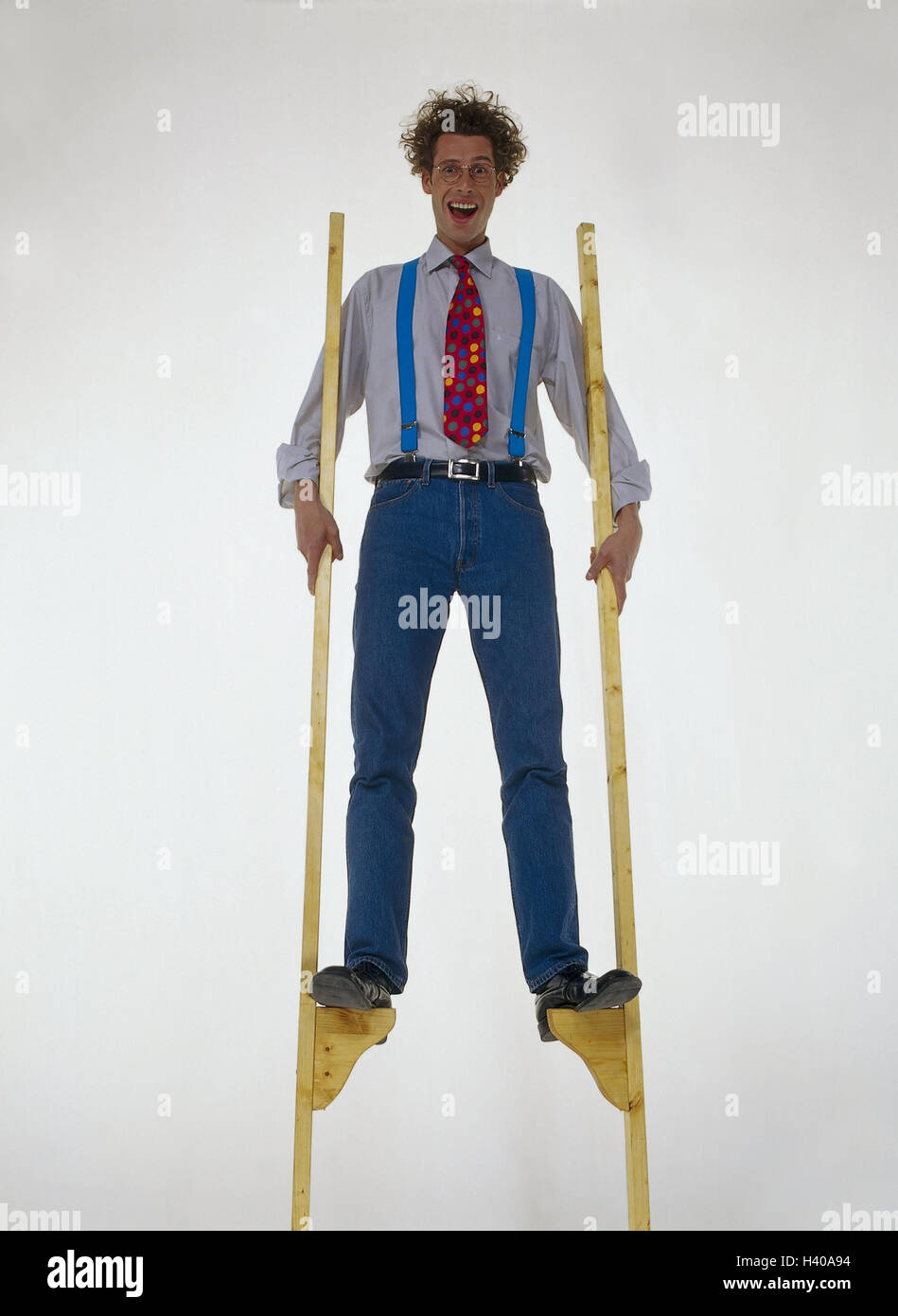 Man, young, laugh, wooden stilts men, inside, studio, cut out, stilts