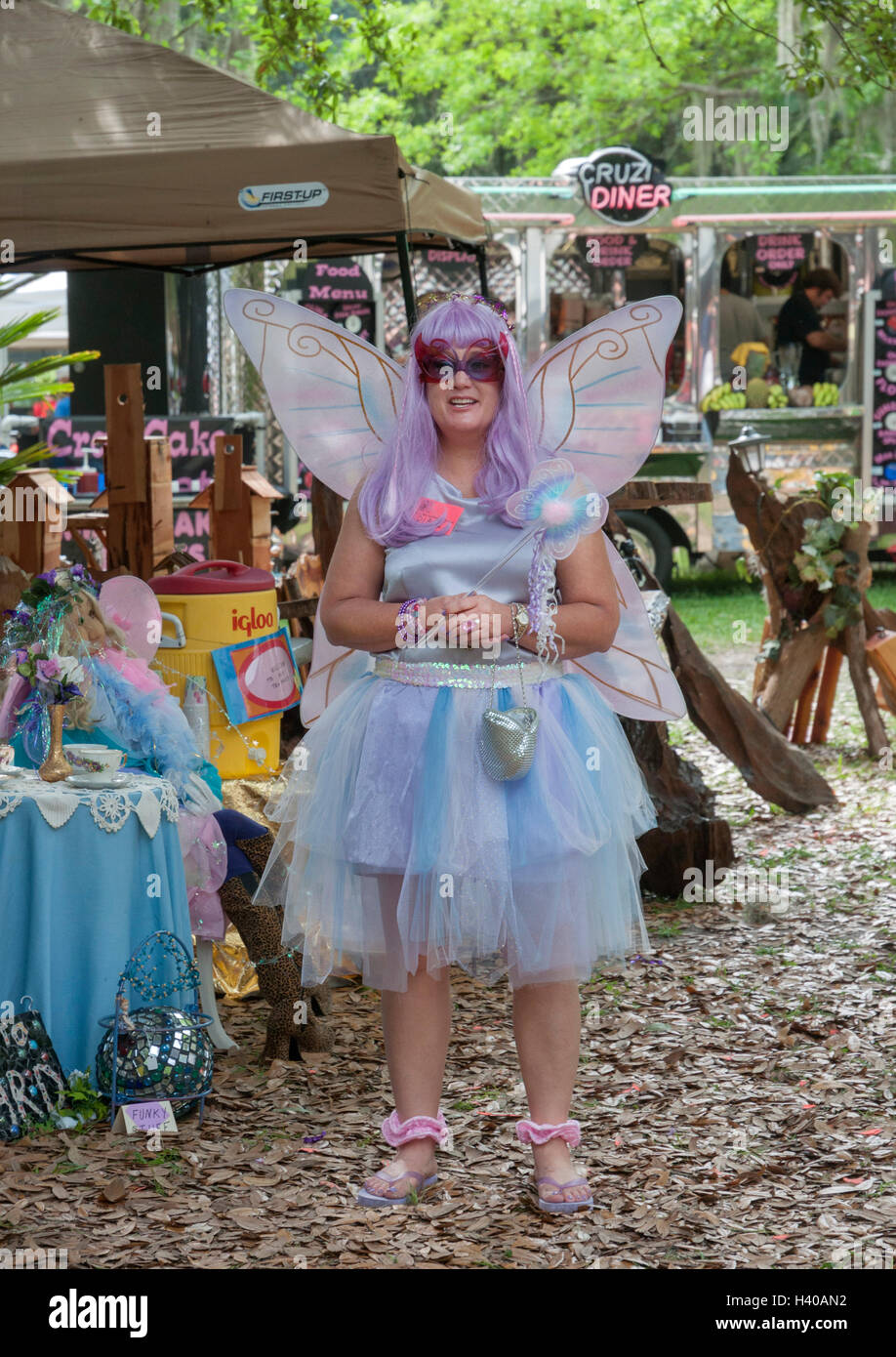 Spring garden festival in a Florida garden Woman vendor dressed like a garden fairy selling garden items Stock Photo Alamy