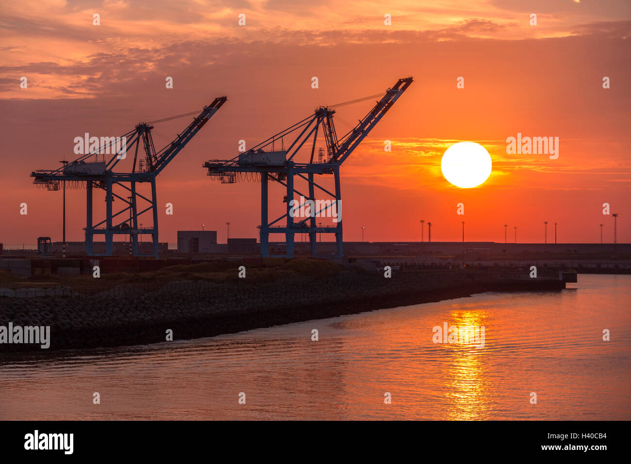 Sunset over one of the many docks in the Port of Zeebrugge in Belgium. Stock Photo