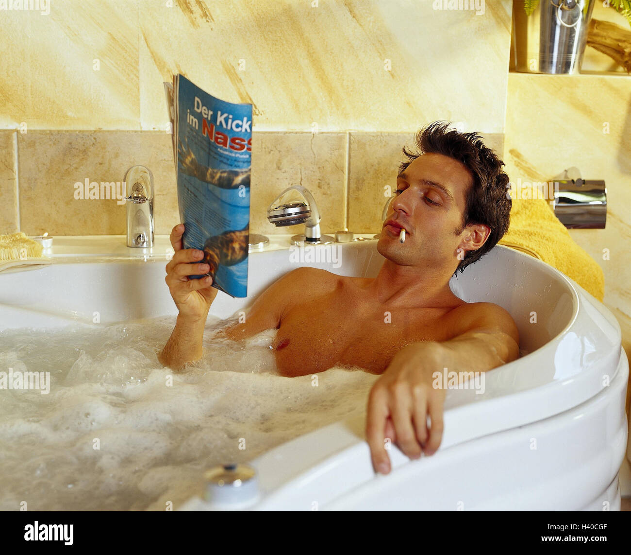 tobacco bath Man, bath, cigarette, smoke, magazine, read, cosmetics, bathroom, bath,  have of a bath, personal care, care, recreation, relaxing, young,  brown-haired, nicotine, smoker, newspaper, inside, near Stock Photo