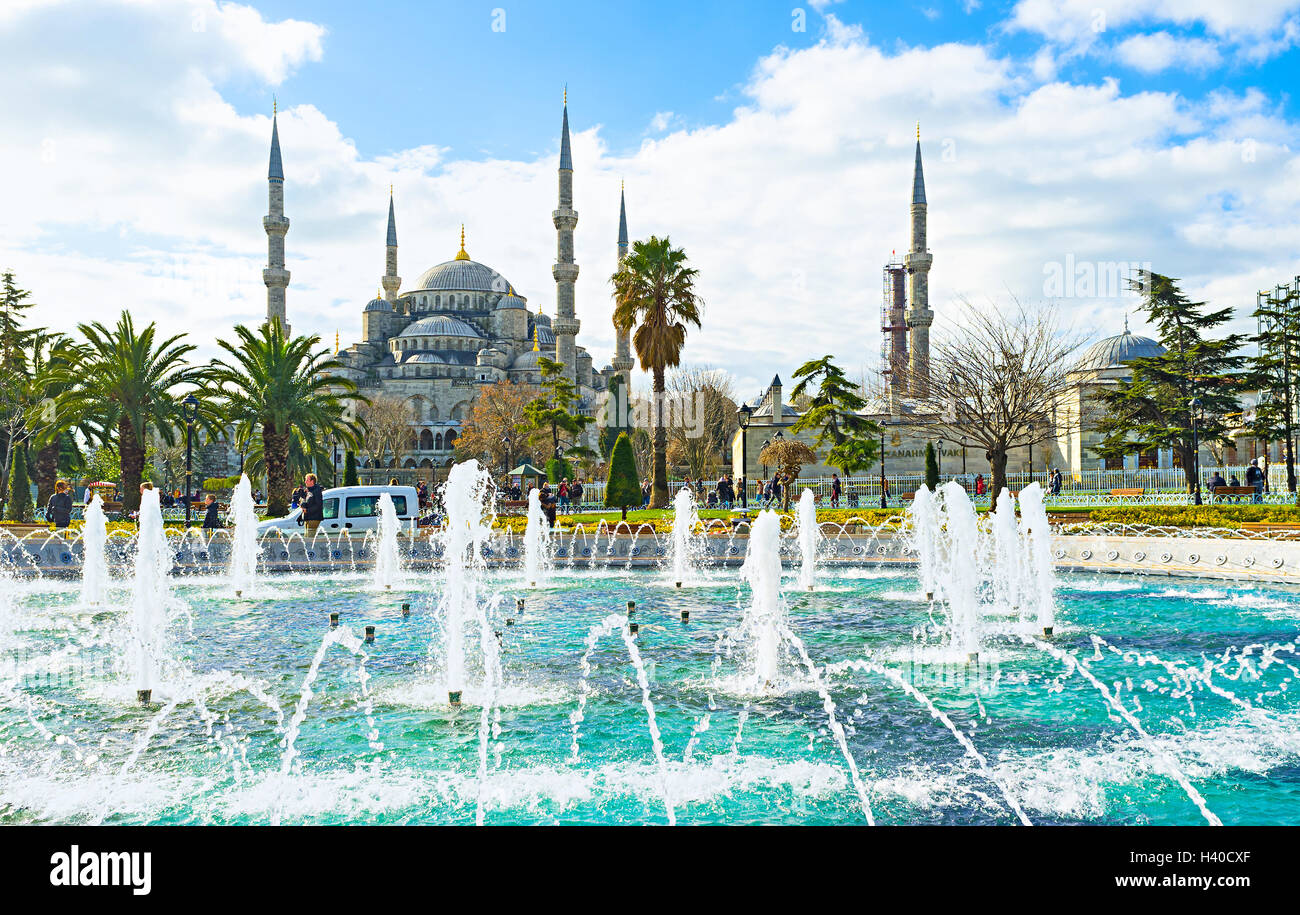 The magnificent Blue Mosque behind the fountain in Sultanahmet park ...