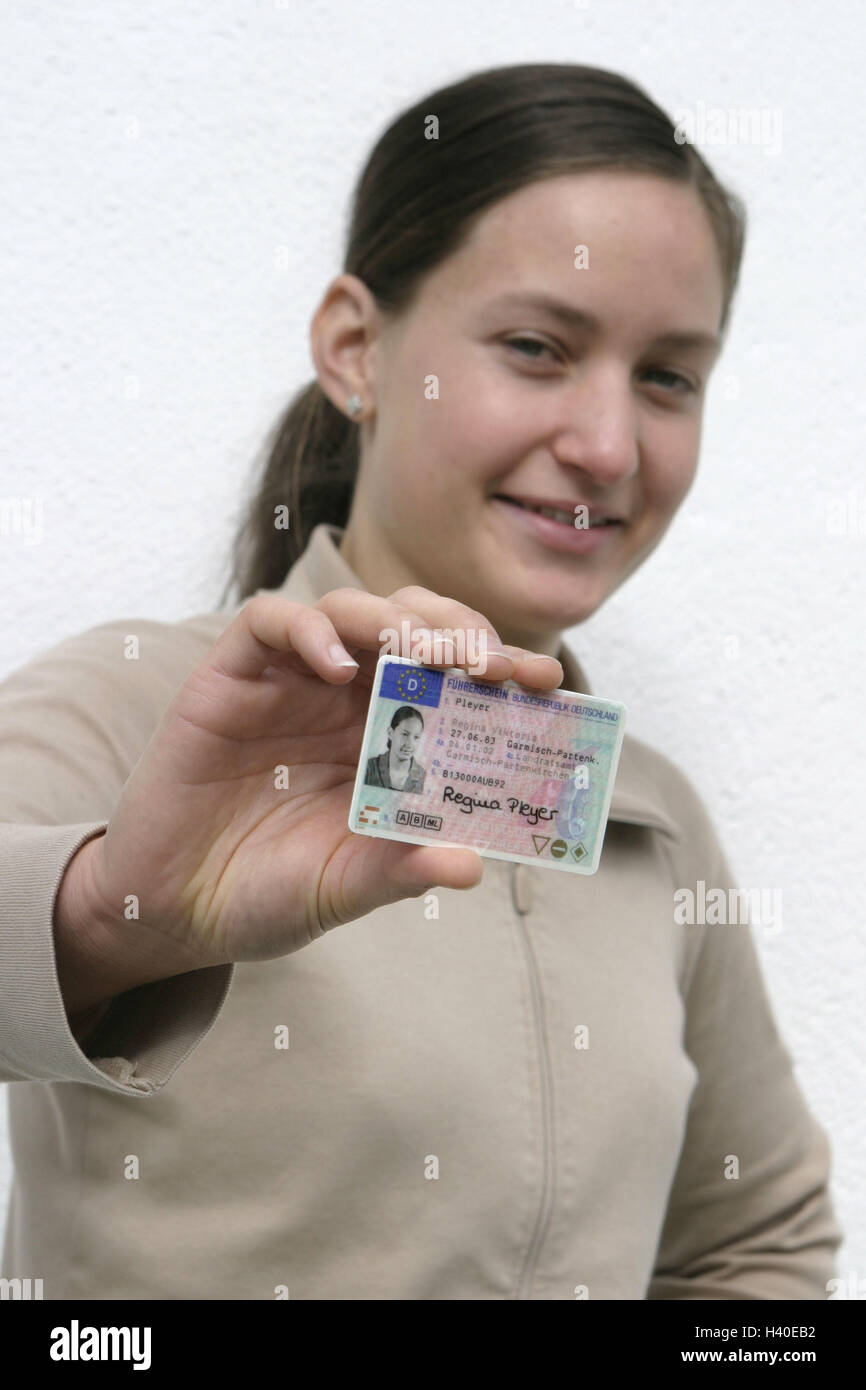 Woman, young, driving licence, point, smile, half portrait, 2030 years