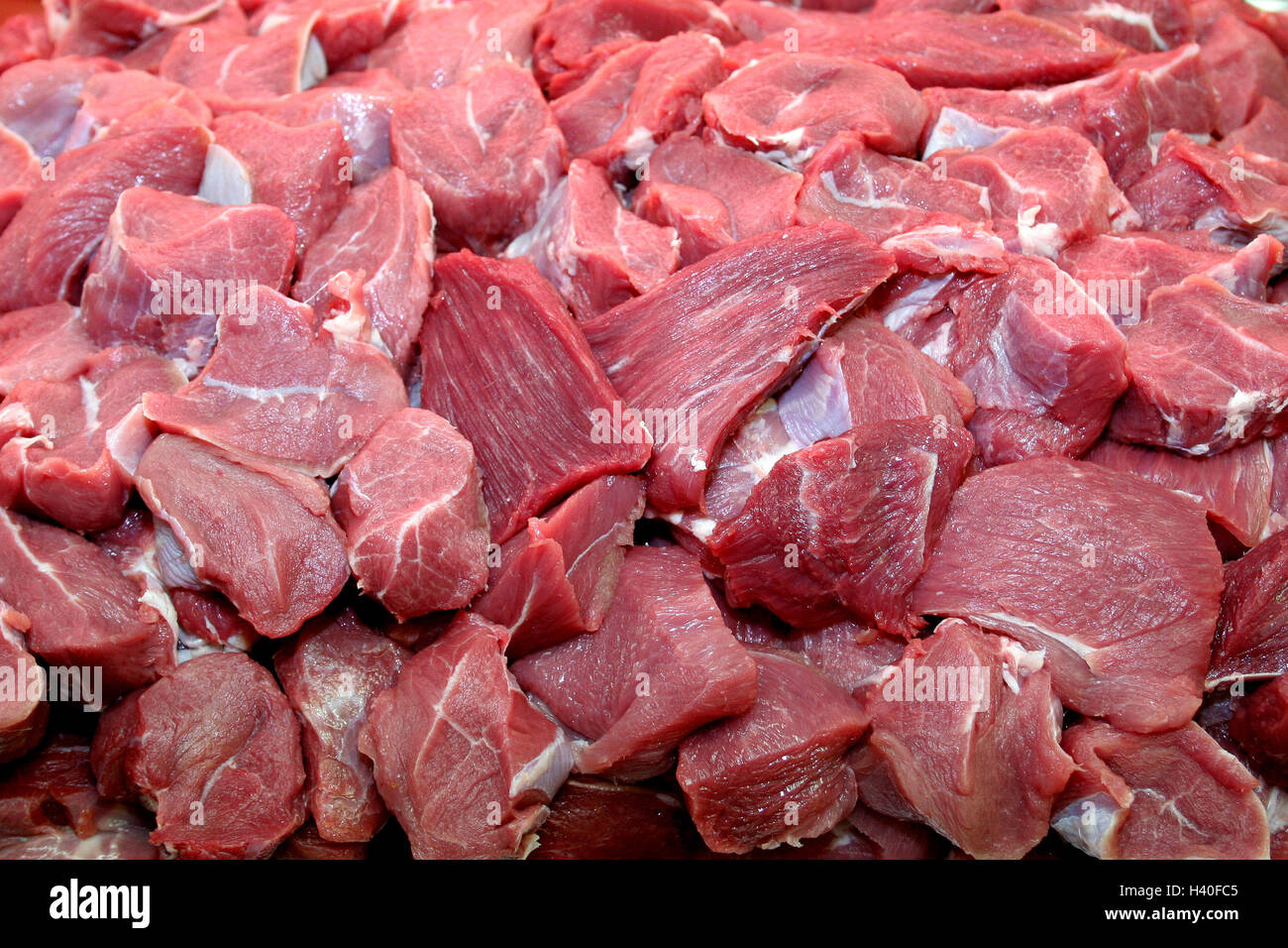 Fresh raw diced red beef meat (chopped in cubes) in a styrofoam container  with copy space for text. Weighing diced meat on scales Stock Photo - Alamy