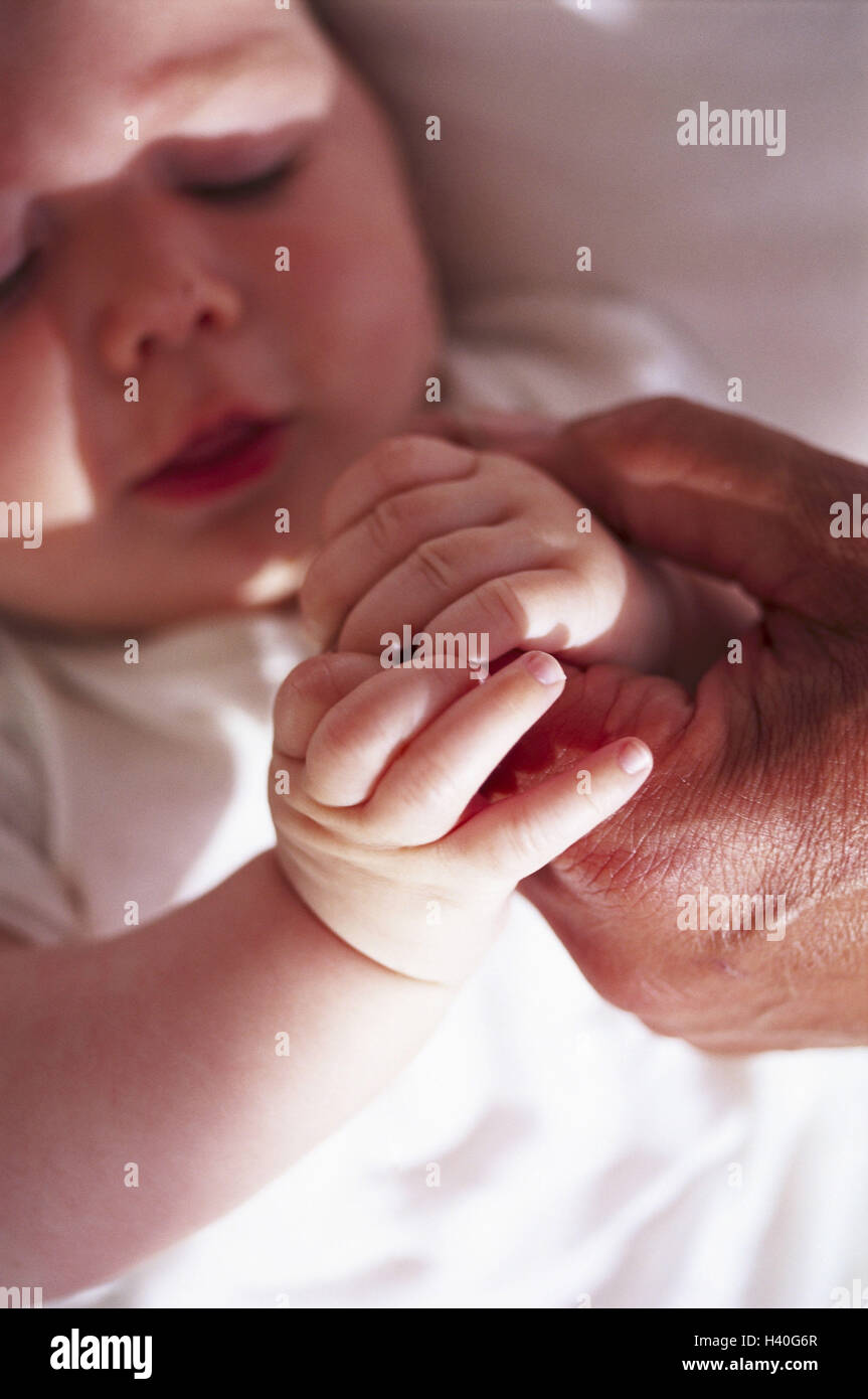 Baby hands, man's hand, stick, baby, child, infant, parts the body, hands, reach, touch, hold, touch, feel, feel, learn, trust, closeness, security, difference, size, skin colour, shell, flatly, creased, softly, roughly, father, grandfather, care, protect Stock Photo