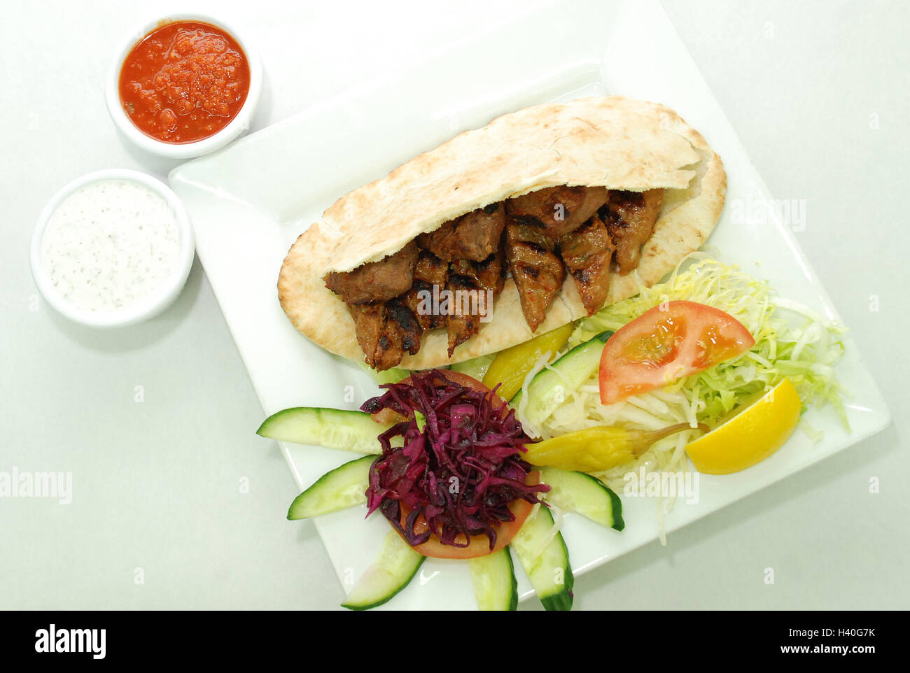 Lamb shish kebab in pita with salad, chilli sauce, garlic sauce Stock