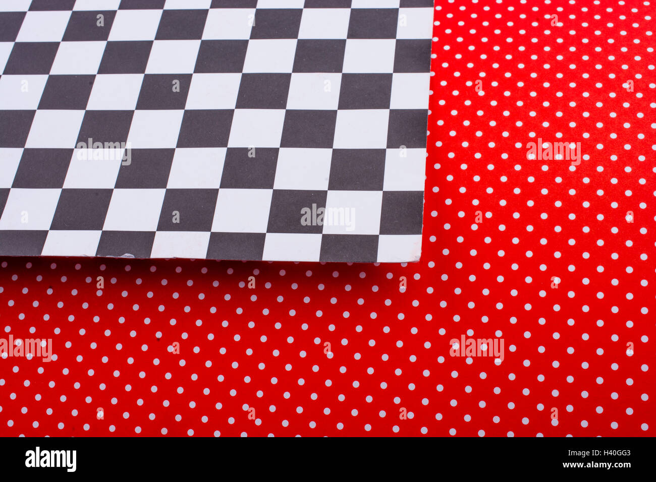 Red dotted paper and black and white checked board pattern Stock Photo