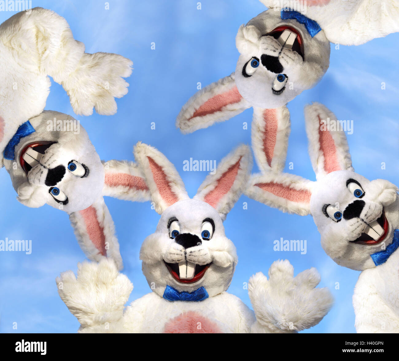 Easter bunnies, cheerfully, waves, circle  stands, portrait, from below  Easter, Easter, child beliefs, disguise, outfit, disguises hare outfit, hares four humor fun merrily, kindly, joy, cleverly, outside, heavens, color mood blue Stock Photo